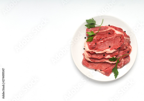 Fresh raw beef steak isolated on white background, top view