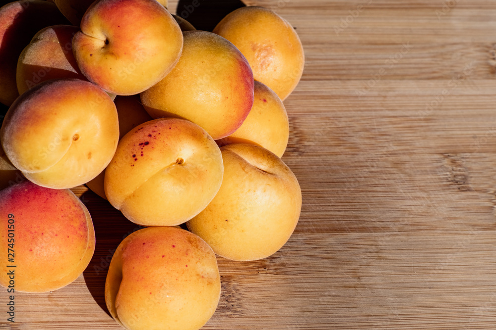 Close up of ripe Blenheim apricots freshly picked, on a wooden table, California Close up of ripe Blenheim apricots freshly picked, on a wooden table, California