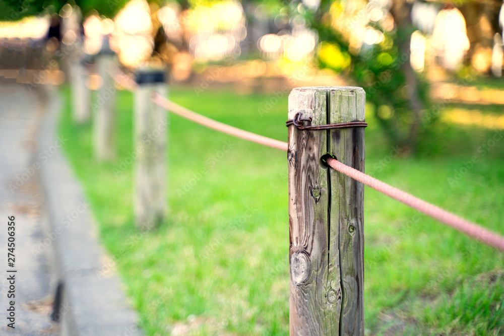 The fence in the garden where the pillars are wooden The fence in the garden where the pillars are wooden