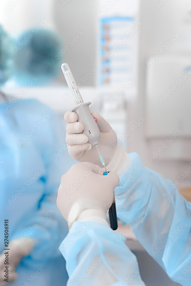 Blood in the test tube in the hands of man. The doctor holds a test tube with blood. Health care. Virus vaccine production. Coronavirus (COVID-19). Blood in the test tube in the hands of man. The doctor holds a test tube with blood. Health care. Virus vaccine production. Coronavirus (COVID-19).