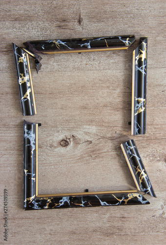 broken photo frame on wooden background