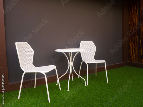 the tables and chairs in front of soft blue wall - Image