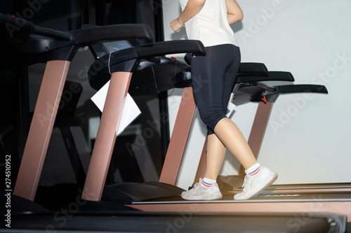 Concept of fitness.Woman running on treadmill in fitness.woman doing cardio training with treadmill