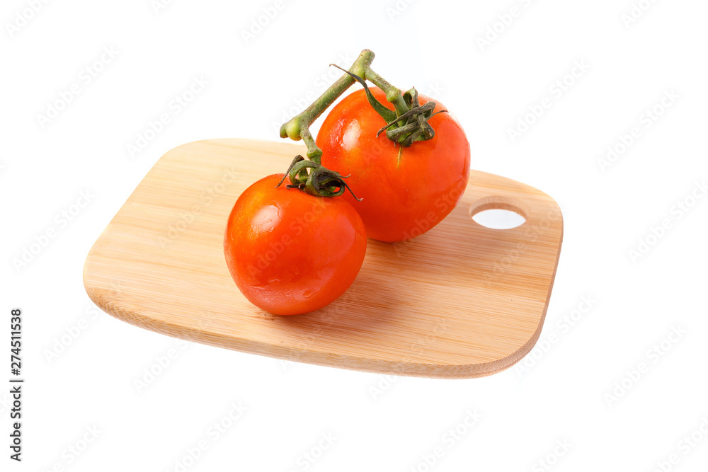 Two tomatoes on cutting board Two tomatoes on cutting board