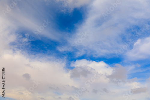 Bright fluffy clouds at morning sky