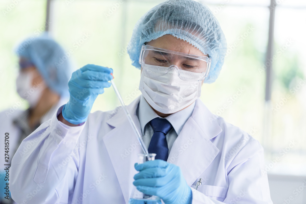 Asian scientist team has researching in laboratory. Asian scientist team has researching in laboratory.