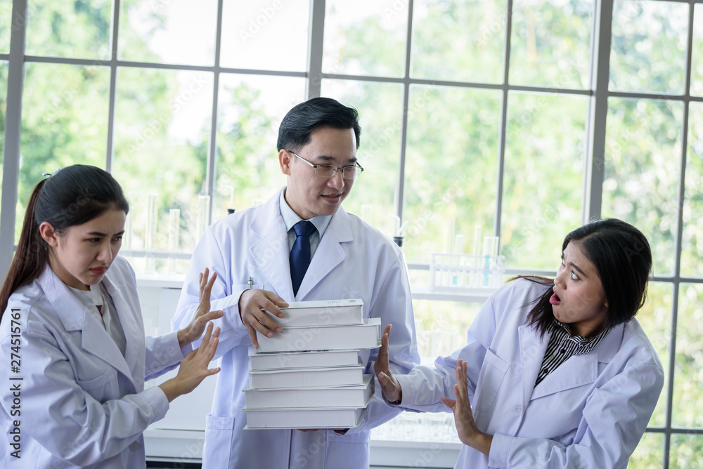 Senior asian scientist has assigning new job to students in laboratory. Senior asian scientist has assigning new job to students in laboratory.