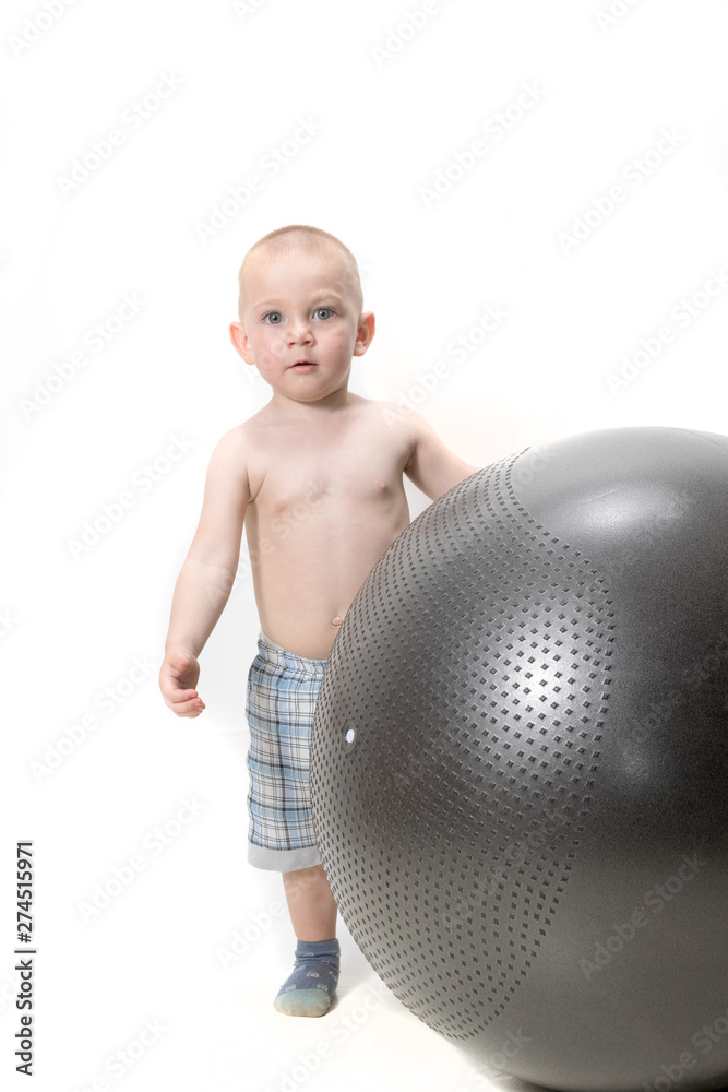 Cute boy playing with fit ball isolated on white Cute boy playing with fit ball isolated on white