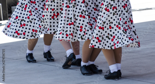 Tap dancers in skirts with floral ornaments
