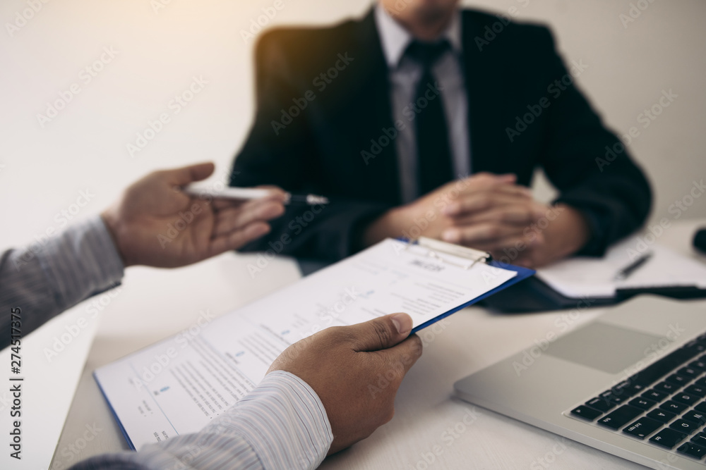 Men are describing the employment history of the employer about his work experience. Men are describing the employment history of the employer about his work experience.