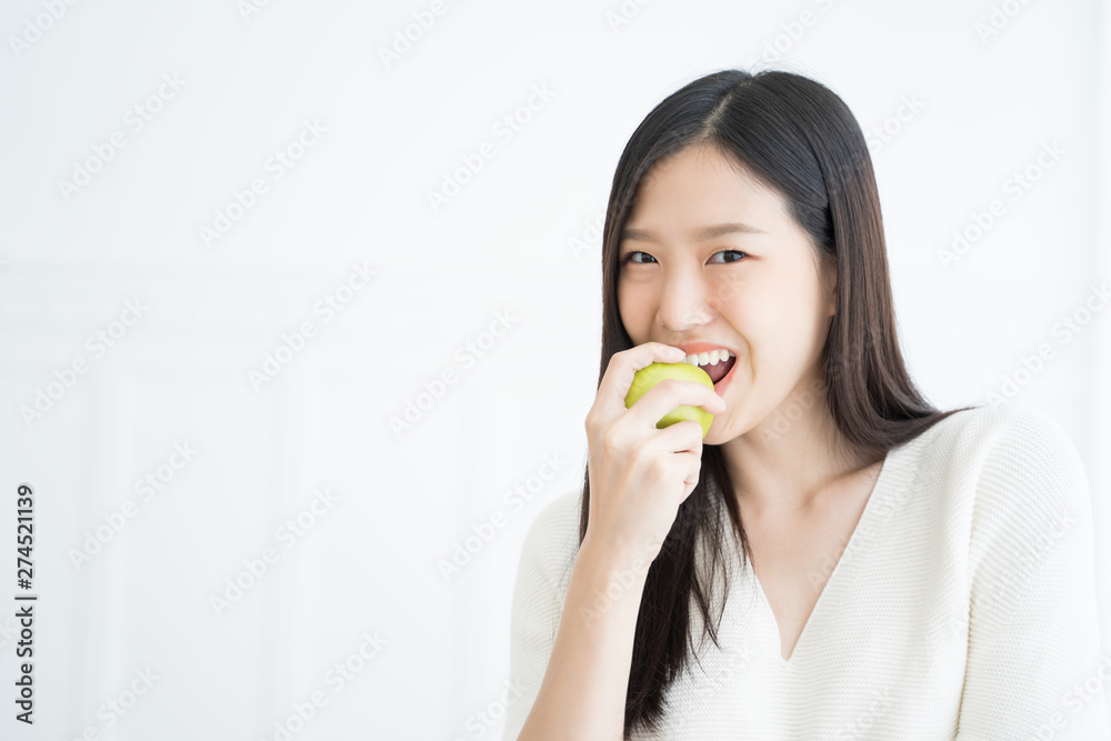 Young Asian woman bite green apple show Strong teeth Young Asian woman bite green apple show Strong teeth