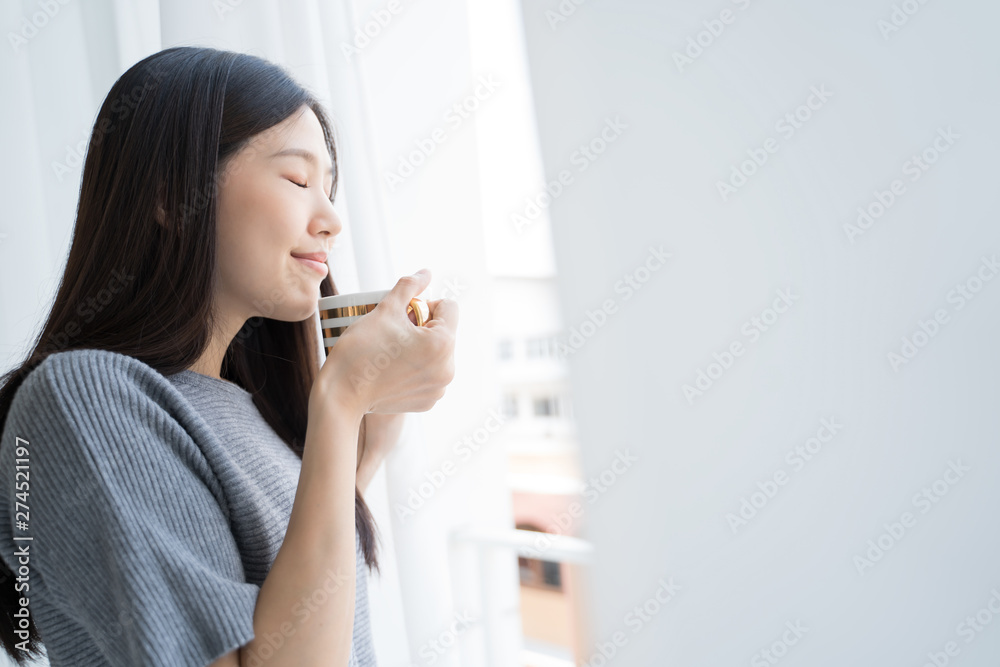 Portrait Asian woman relaxing with coffee at home Portrait Asian woman relaxing with coffee at home