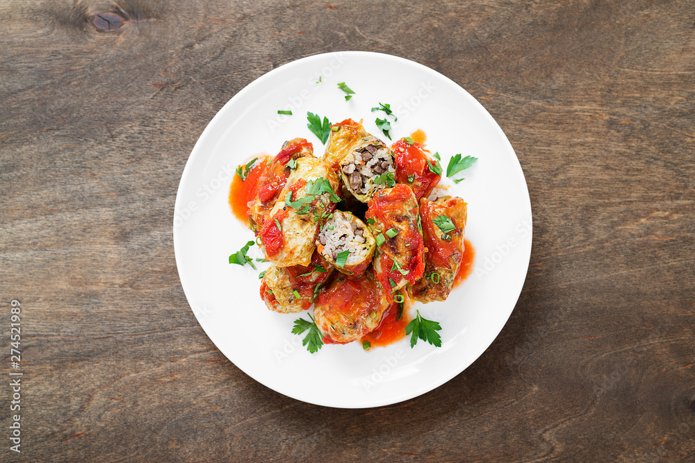 Traditional stuffed cabbage rolls with minced meat and rice, served in a tomato sauce.