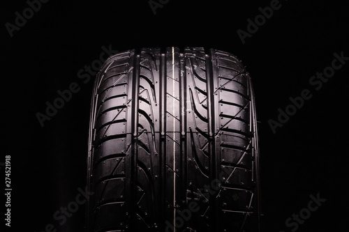 new summer tire, tire tread. Close-up, black background photo