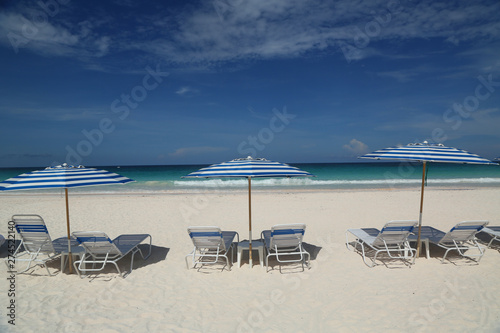 Beach chairs and umbrella on a beautiful Caribbean beach at Harbor Island  Bahamas