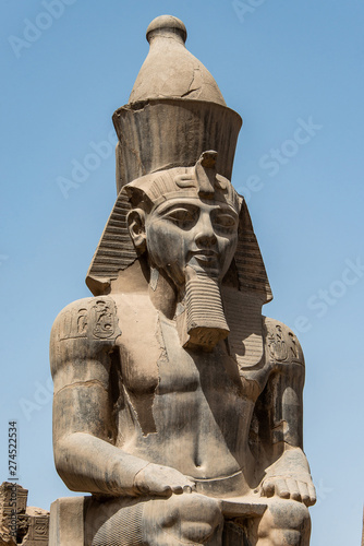 Egypt Luxor Temple. granite Statue of Ramesses II seated in front of columns