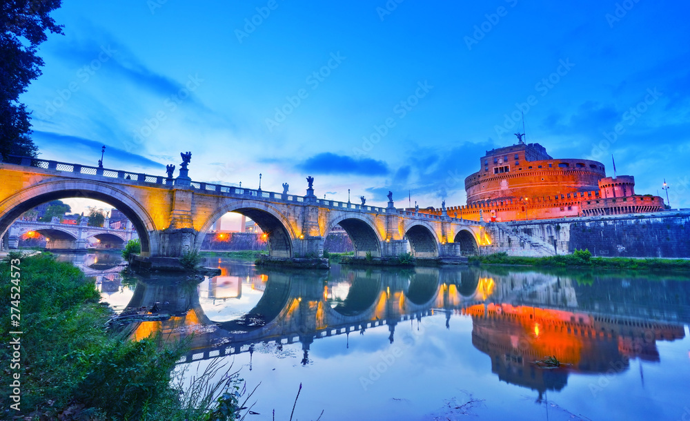View of the Castel Sant'Angelo and Aelian Bridge in Rome at night.