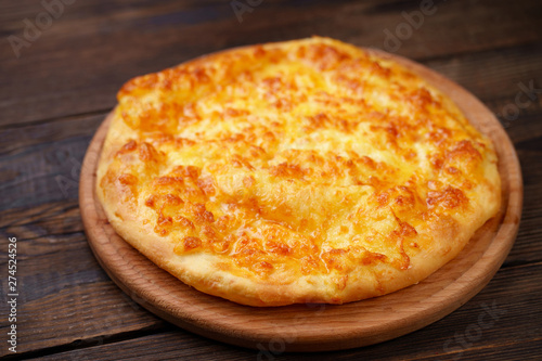 Traditional Georgian meal. Megrelian Khachapuri with Melted Cheese filling.