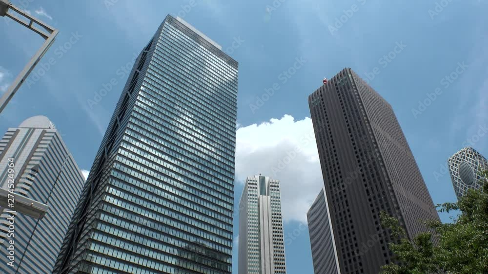 SHINJUKU, TOKYO, JAPAN : View of looking up tall modern buildings and sky in day time. Famous business district in Tokyo, where many company office buildings are located. SHINJUKU, TOKYO, JAPAN : View of looking up tall modern buildings and sky in day time. Famous business district in Tokyo, where many company office buildings are located.