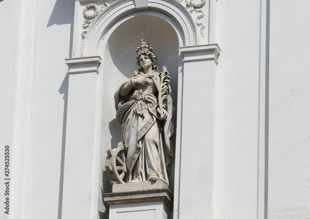 Beautiful statue of a woman saint on the church portal