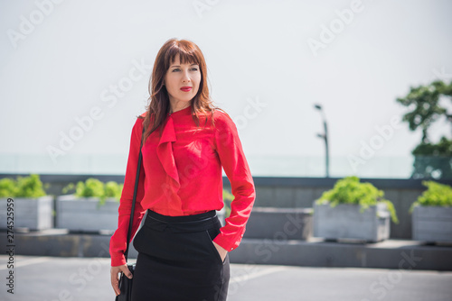 Business woman in city wear red shirt and black skirt, bussinestyle for women 