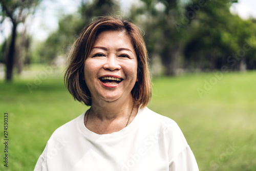 Portrait of happy senior adult elderly asia women smiling and looking at camera in the park.Retirement concept