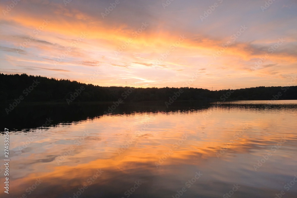 Beautiful sunset on the lake or river. Nature background.