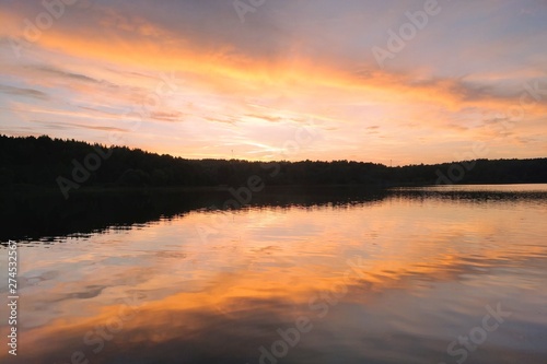 Beautiful sunset on the lake or river. Nature background.