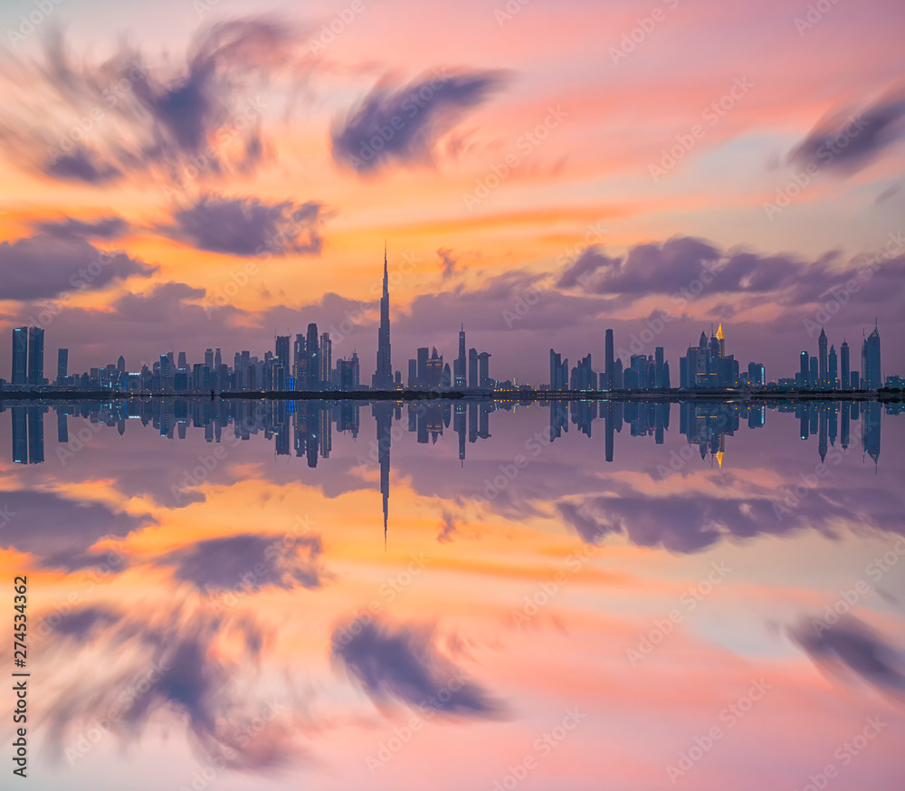 Naklejka premium Skyline Dubai City reflection during sun-set 