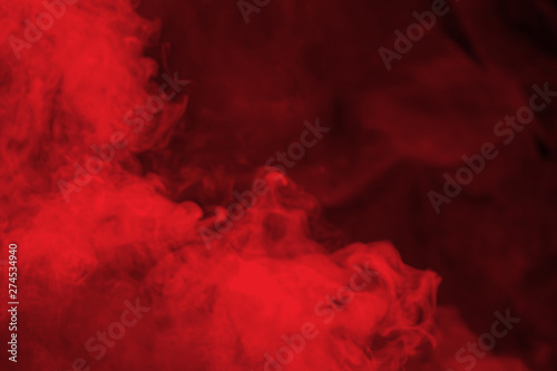 Abstract red  smoke on black background. Dramatic red smoke clouds. Movement ...