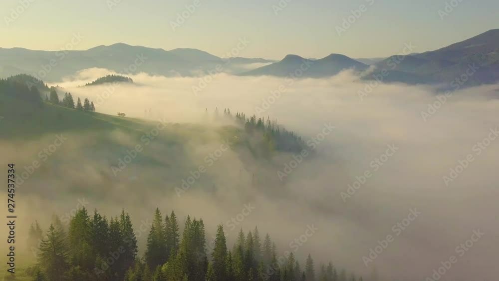 Surreal sunrise in the Smoky mountain skies. Drone video lifting up and panning to reveal the sunrise through the clouds in the Blue Ridge Great Smoky Mountains of Tennessee