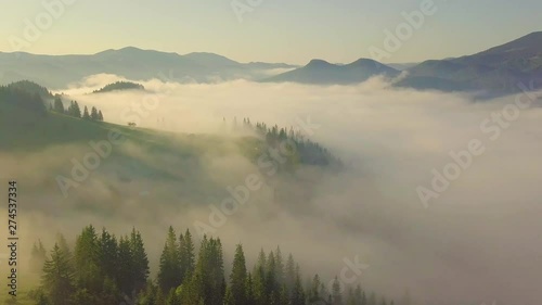 Surreal sunrise in the Smoky mountain skies. Drone video lifting up and panning to reveal the sunrise through the clouds in the Blue Ridge Great Smoky Mountains of Tennessee