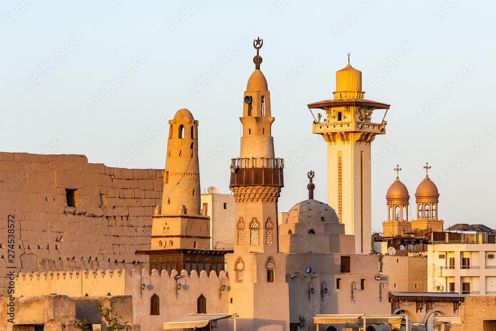 catholic Church and Muslim Mosque Tower religion Symbols together in Luxor temple at sunset