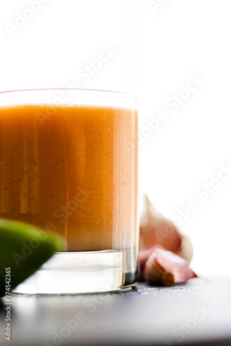 Healthy refreshing drink in a glass surrounded by fruits and vegetables photo