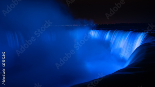 Niagara Falls illuminated in glowing blue colours