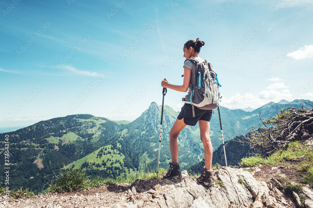 Fit young woman hiking in the mountains - obrazy, fototapety, plakaty 