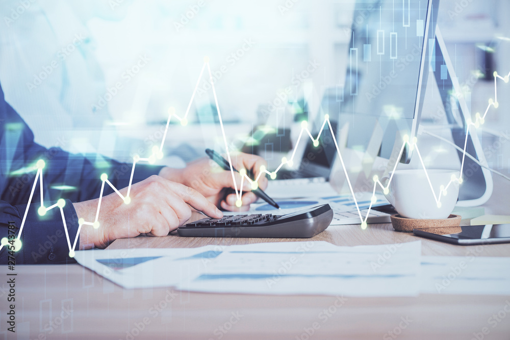 Naklejka premium Forex graph with businessman working on computer in office on background. Concept of hardworking. Closeup. Multi exposure.
