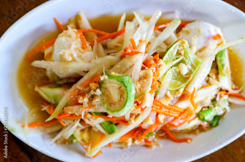 Thai food, papaya salad in a white dish with a blurred background