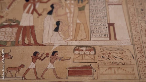 Opening of the Mouth Ceremony, GI of an ancient Egyptian papyrus paper, tilt up shot, shallow depth of field.