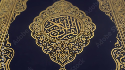 Quran blue cover decorated with gold, shallow depth of field close-up slow tilt up CGI shot.