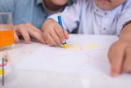 Asian family doing school homework at living room