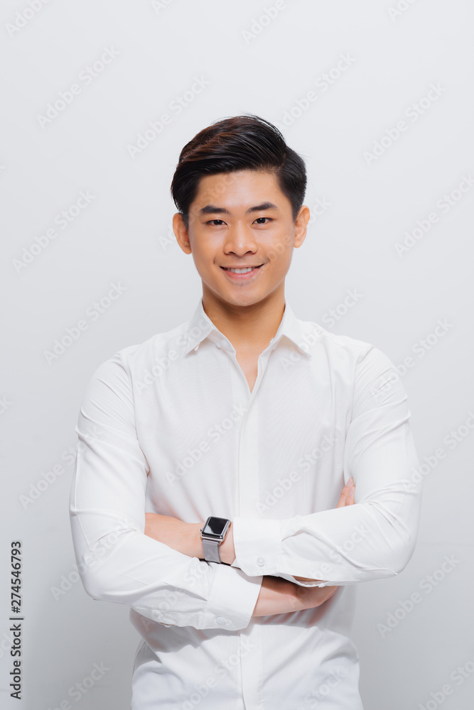 Asian man in shirt, looking on camera, with folded hands Asian man in shirt, looking on camera, with folded hands
