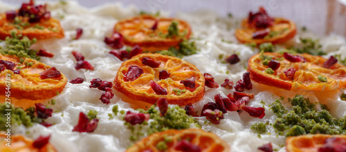 traditional Turkish dessert: gullac; with peanuts, dried orange slices and dried pomegranate seeds