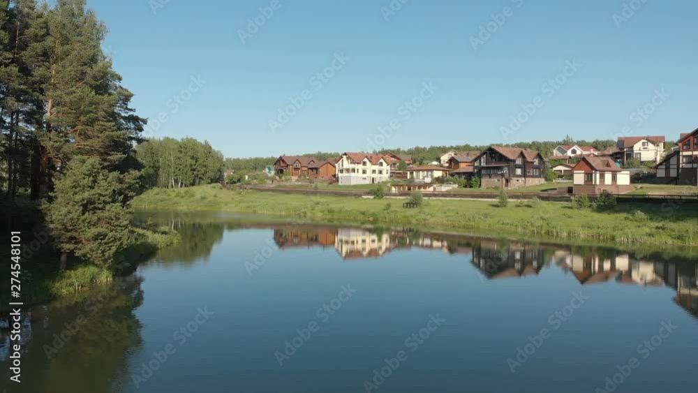 View of the country village. Flying drone above the pond. Video without color correction 4K View of the country village. Flying drone above the pond. Video without color correction 4K