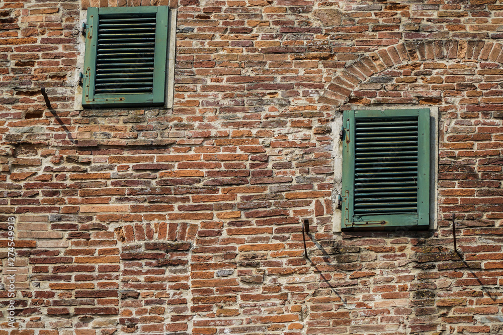 green window blinds of a brick house