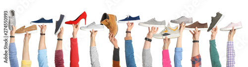 Set of people holding different stylish shoes on white background, closeup