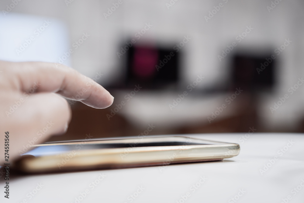 Online searching social networks by Smartphone Concept: Hand of young man pointing finger on blank screen smart phone, using hand clean gadget or typing sms message to his friends on table background Online searching social networks by Smartphone Concept: Hand of young man pointing finger on blank screen smart phone, using hand clean gadget or typing sms message to his friends on table background