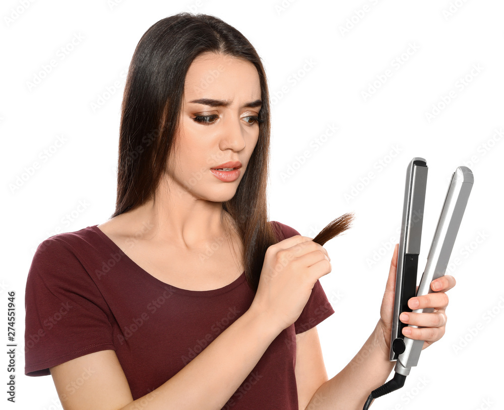 Emotional woman with hair iron on white background Emotional woman with hair iron on white background