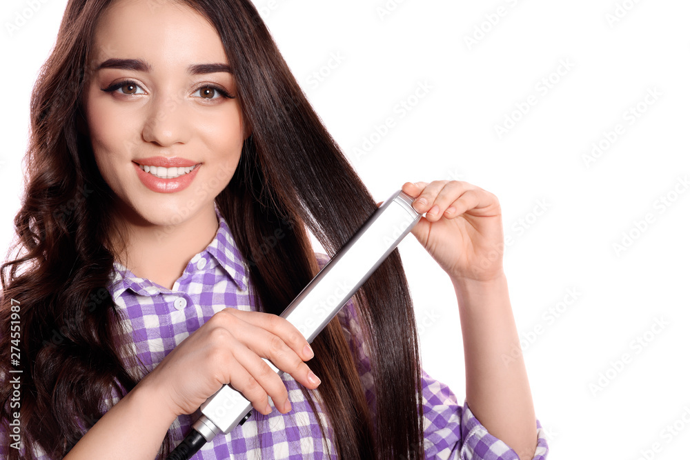 Happy woman using hair iron on white background Happy woman using hair iron on white background
