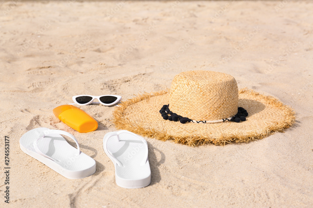 Set of different stylish beach accessories on sand Set of different stylish beach accessories on sand